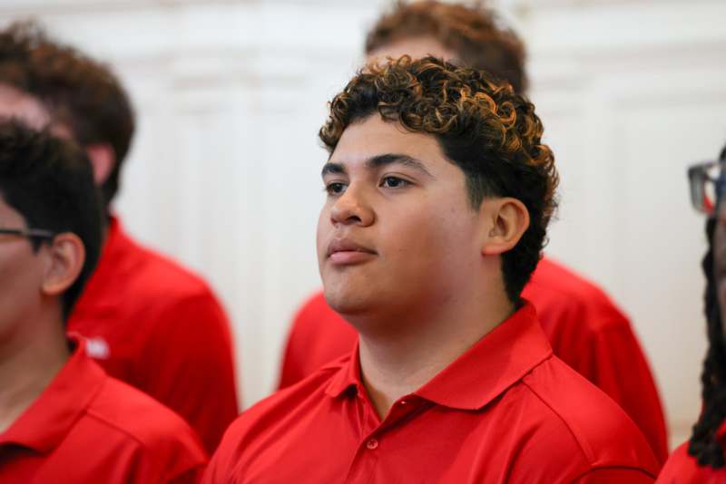 a group of people in red shirts
