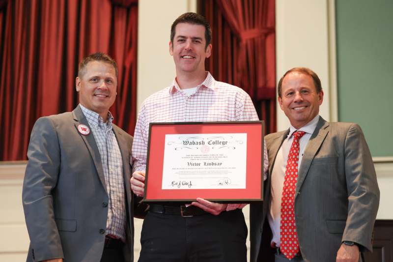 a group of men holding a certificate