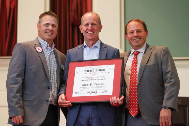 a group of men holding a certificate