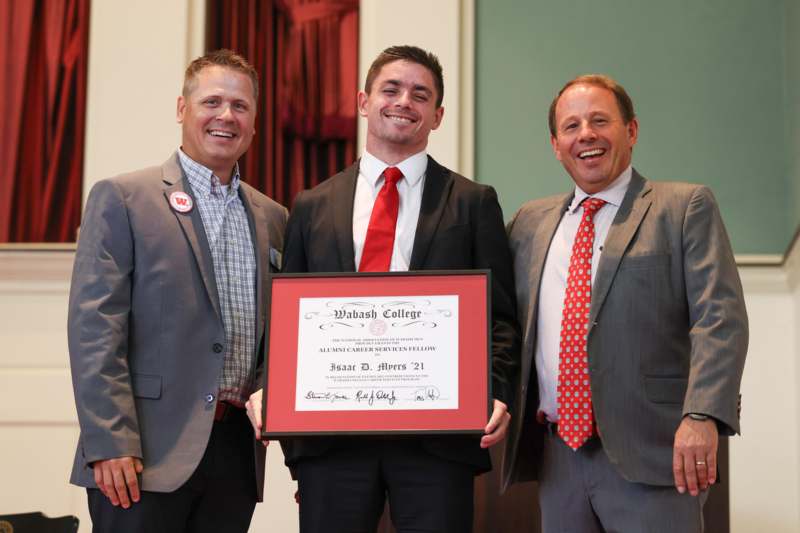 a group of men holding a certificate