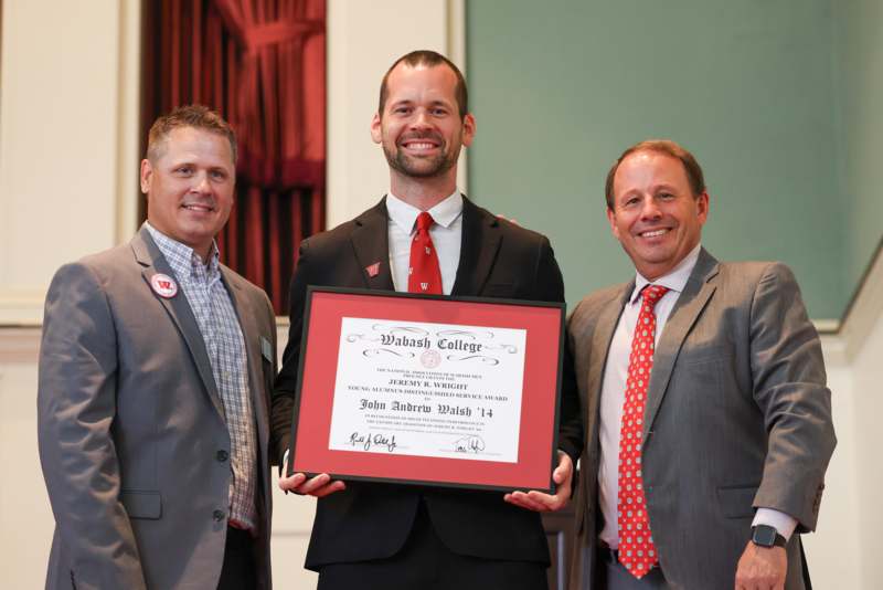 a group of men holding a certificate