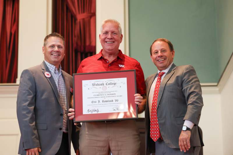 a group of men holding a certificate
