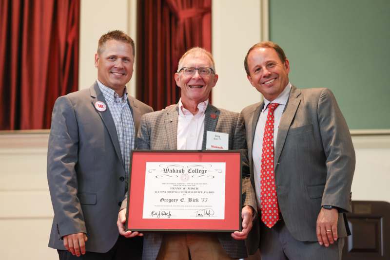a group of men holding a certificate