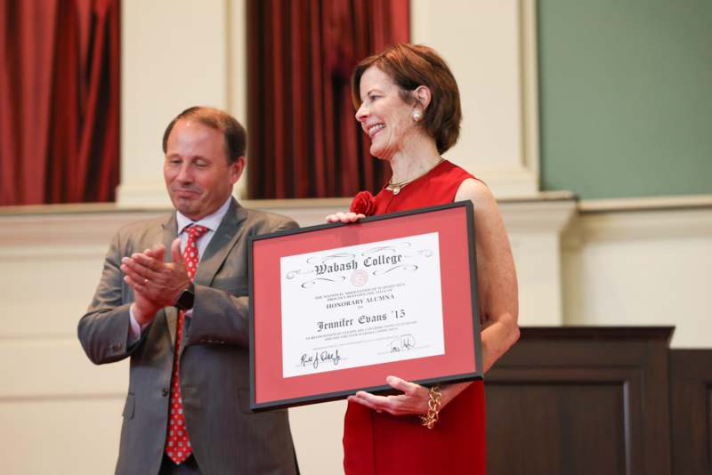 a man and woman holding a certificate