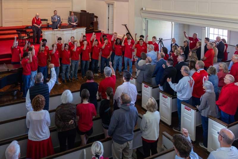 a group of people standing in a church
