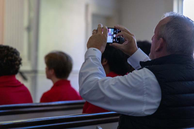 a man taking a picture of a group of people