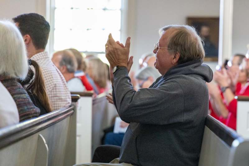 a man clapping in a church