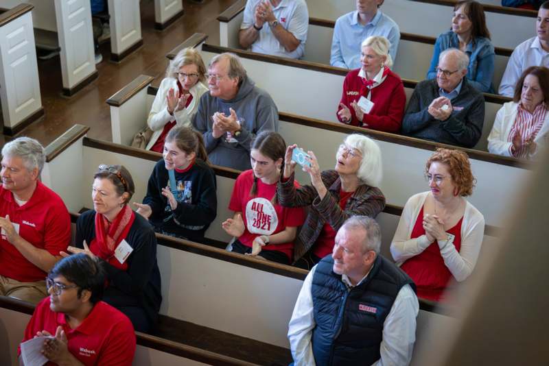 a group of people sitting in pews