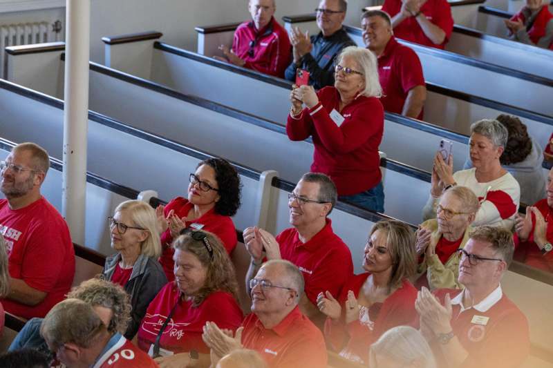 a group of people in red shirts