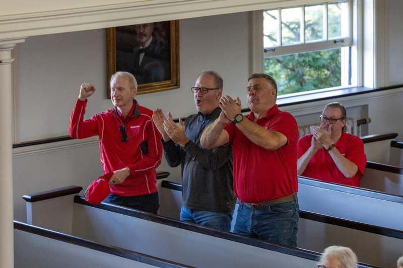 a group of men clapping in a church