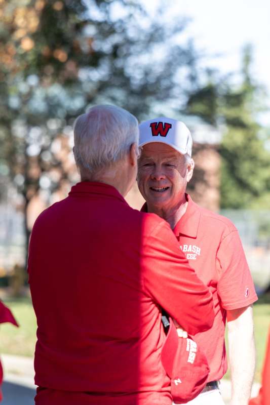two men in red shirts