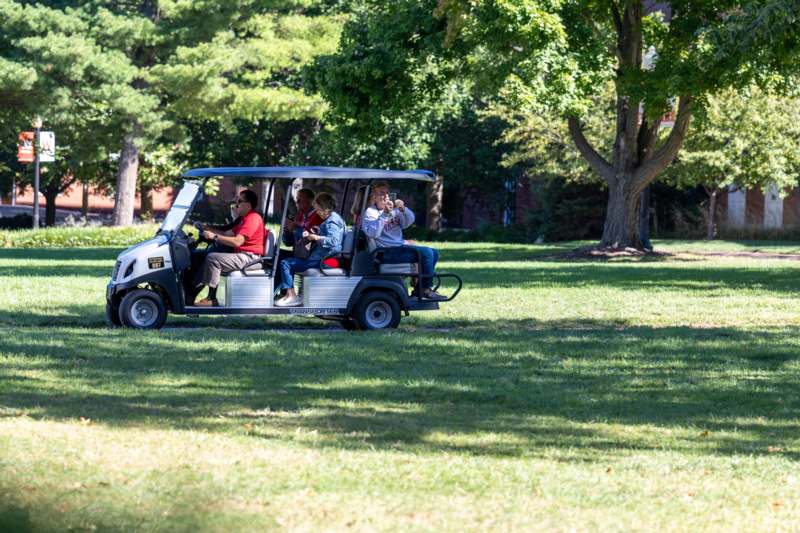 a group of people in a golf cart