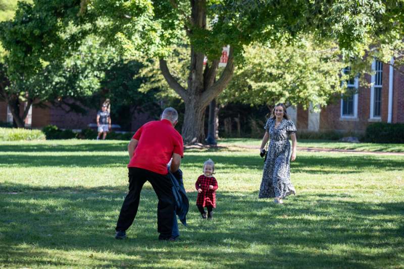 a man and woman walking in a park