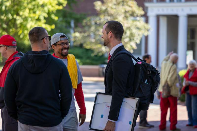 a group of men talking to each other