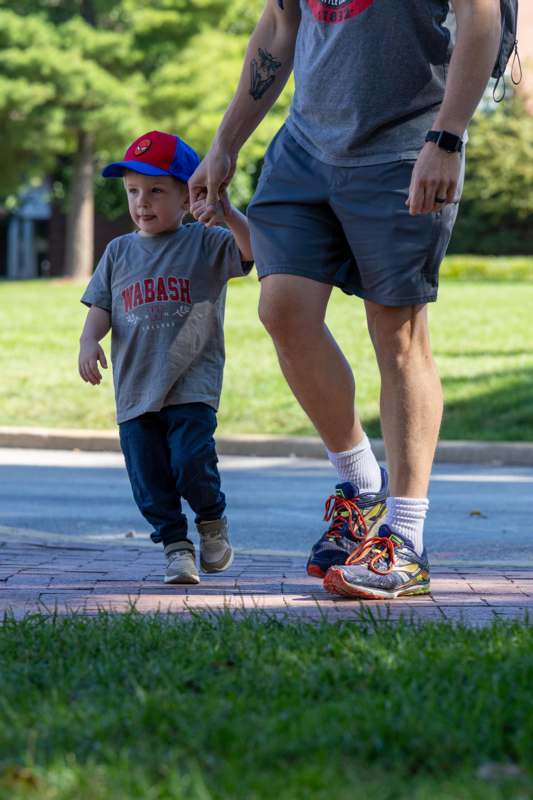 a man holding a child's hand