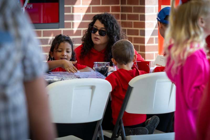 a woman and children sitting at a table