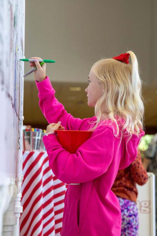a girl writing on a whiteboard
