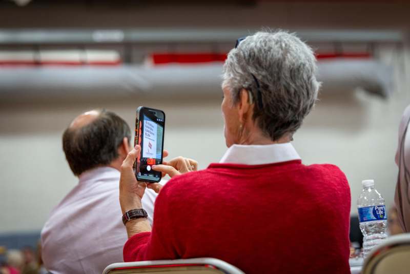a woman taking a picture of a man