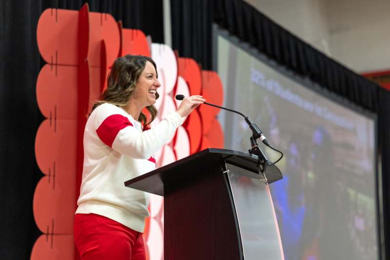 a woman standing at a podium with a microphone