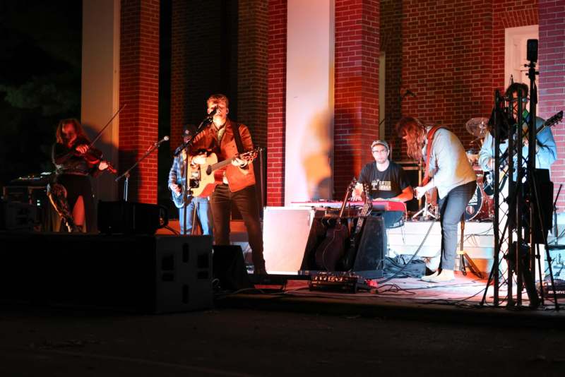 a group of people playing instruments on a stage