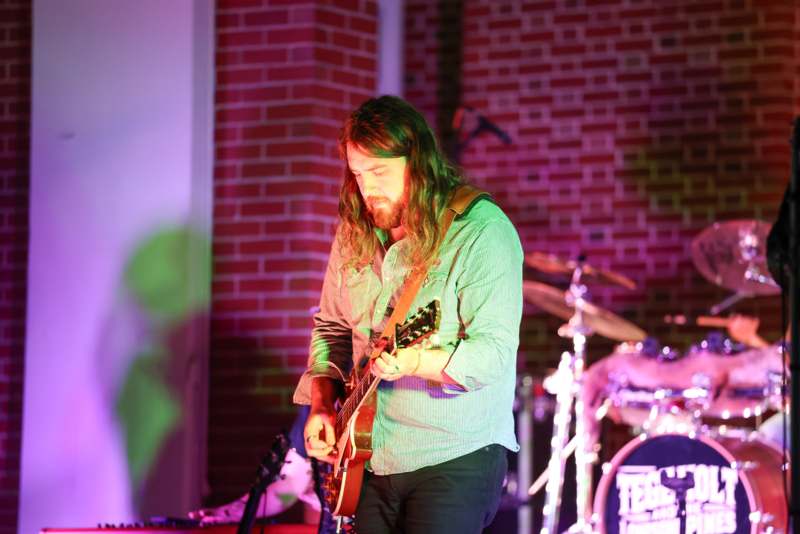 a man playing a guitar on a stage