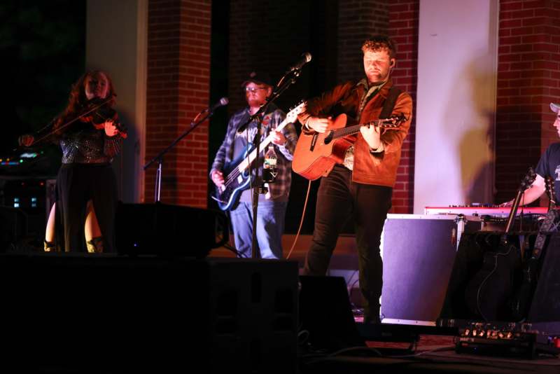 a group of people playing instruments on a stage