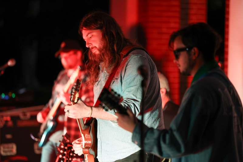 a group of people playing guitars