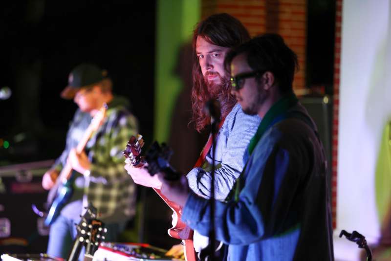 a group of men playing guitars
