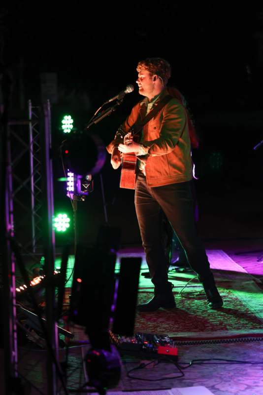 a man playing guitar on stage