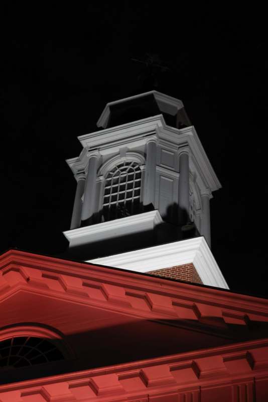 a tall white tower with a red roof
