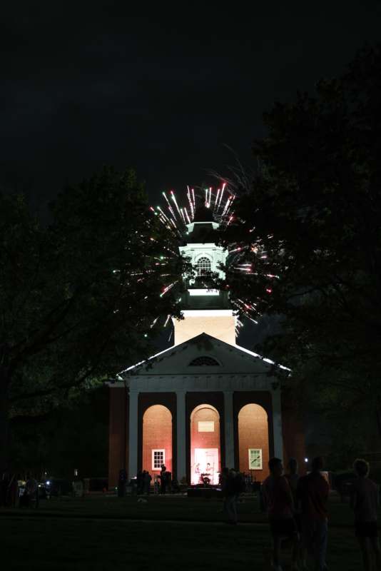 a building with fireworks in the sky