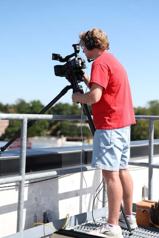 a man with headphones and a camera on a tripod
