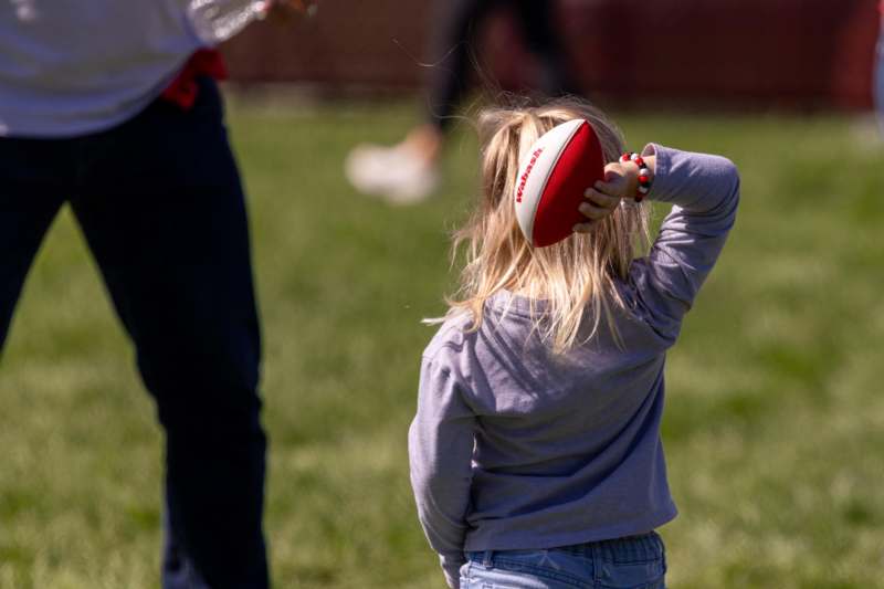 a girl holding a football