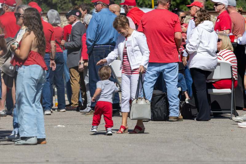 a woman and a child walking in a crowd