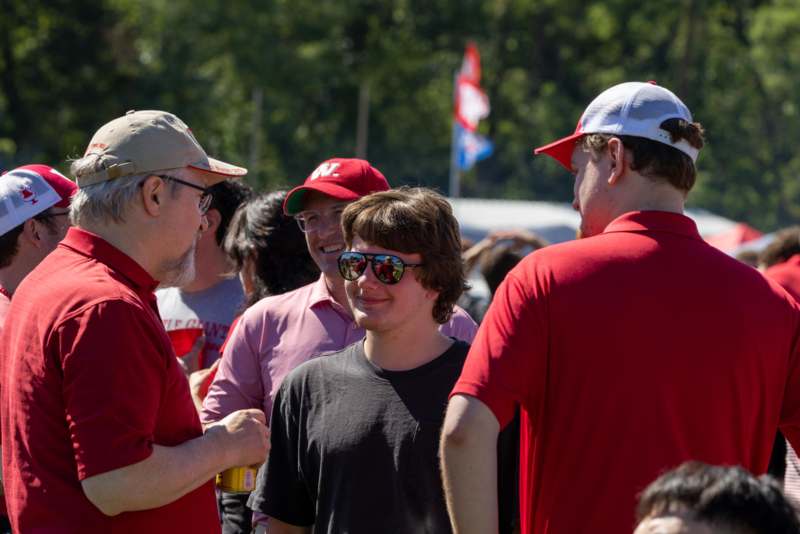a group of people in red shirts
