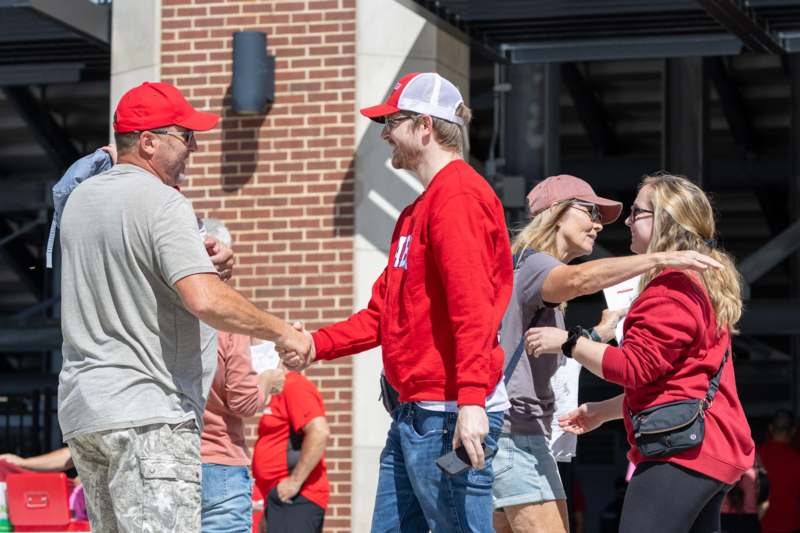 a group of people shaking hands outside