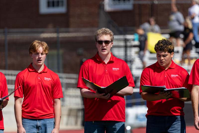 a group of men in red shirts