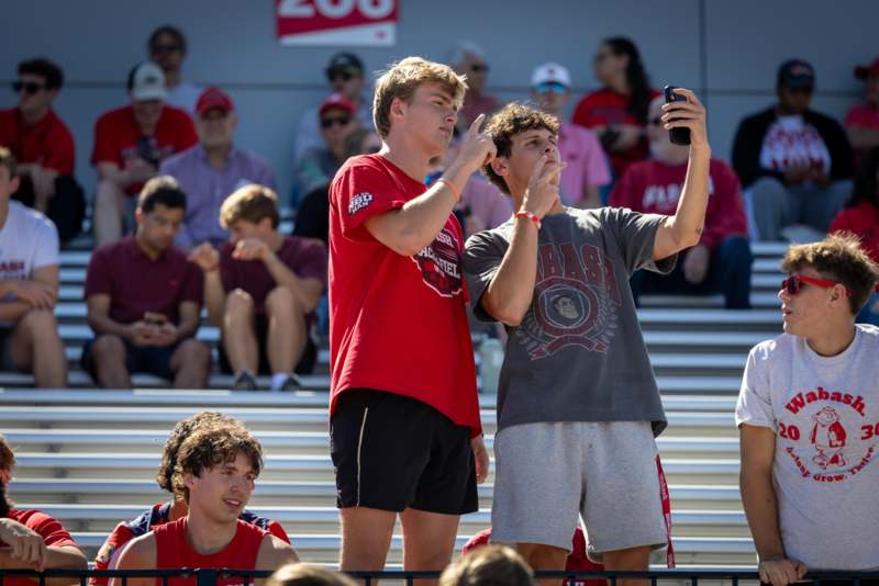 a group of men standing in bleachers