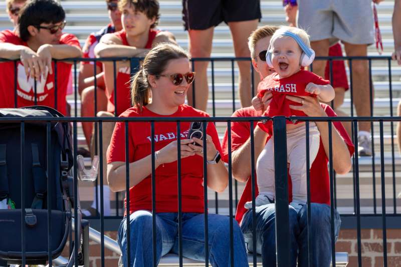 a group of people sitting on bleachers