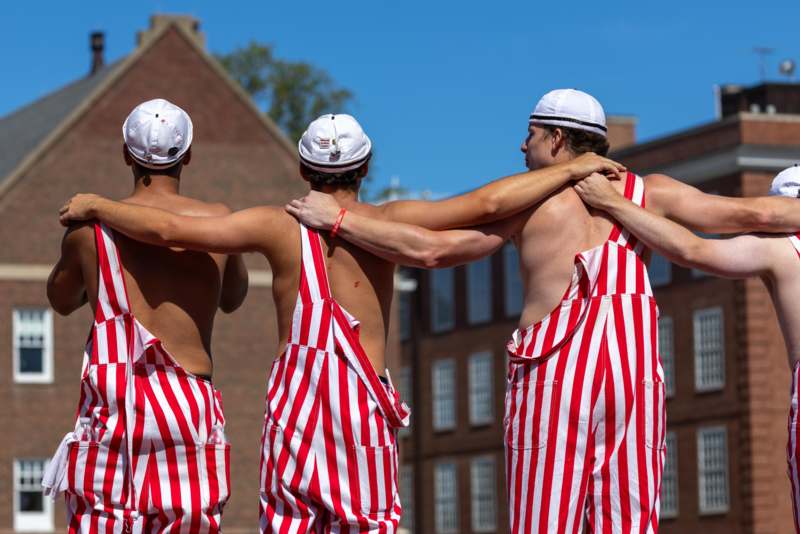 a group of men wearing striped overalls