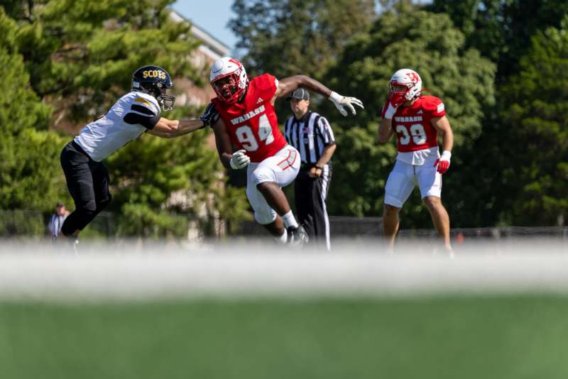 a football player running with another football player in the air