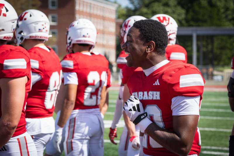 a football player laughing while wearing a red uniform