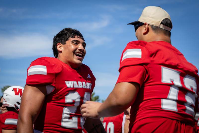 a group of football players in red jerseys