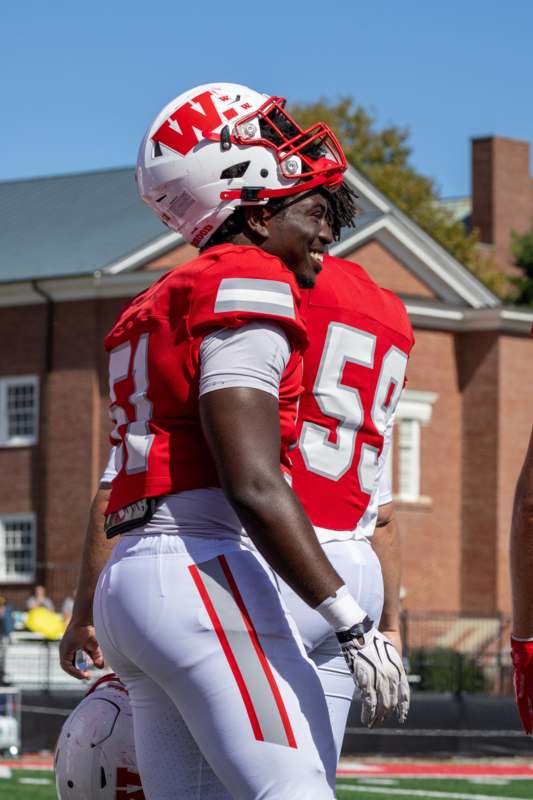 a football players wearing red and white jerseys and helmets