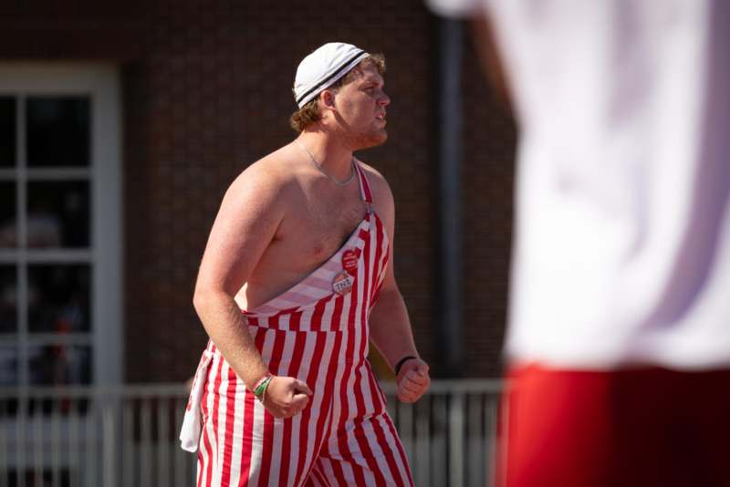 a man in red and white striped overalls running
