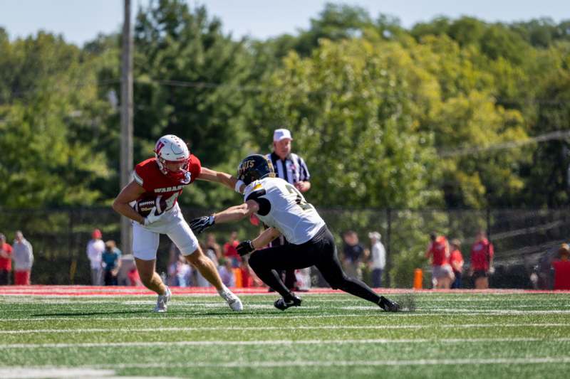 a football player running with another football player