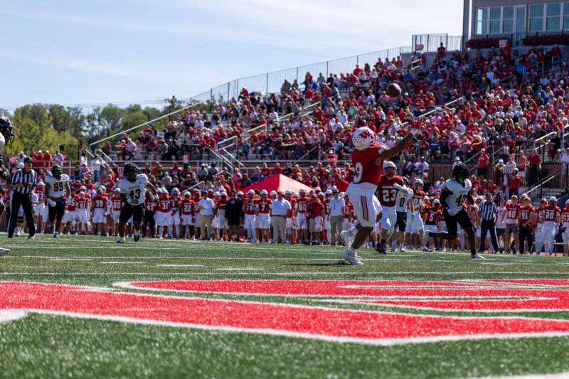 a football player throwing a football in a game