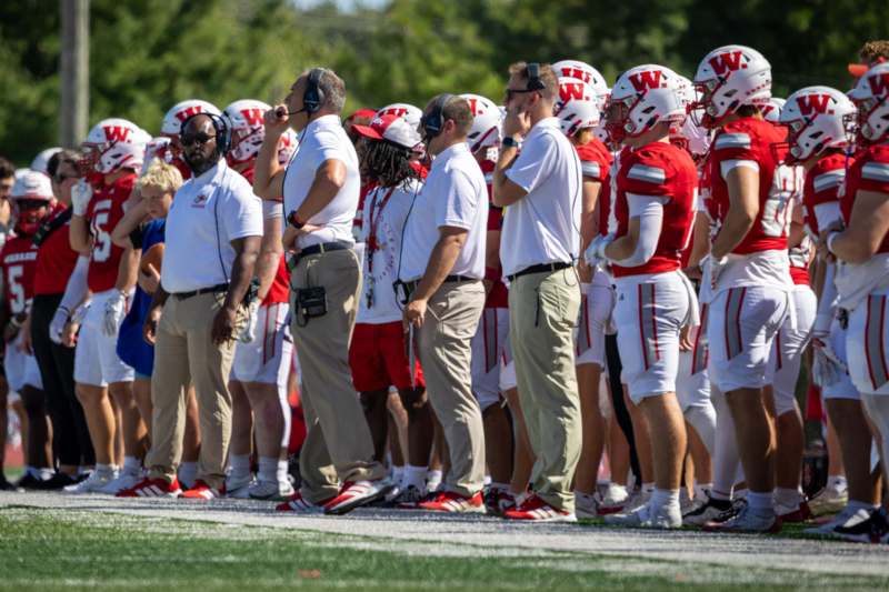 a group of football players standing on a field