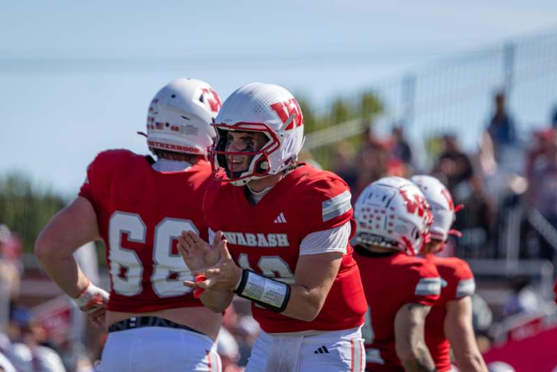 a group of football players clapping