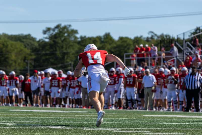 a football player running on a football field